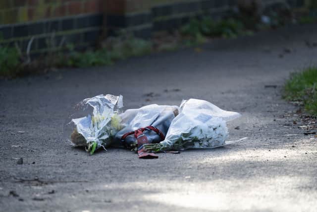 Flowers left at the scene where Roberts Buncis was murdered.