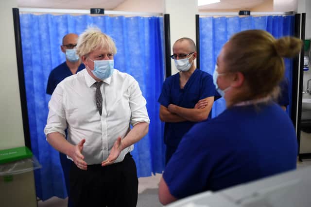 Johnson was later pictured wearing a mask while visiting wards in the hospital (Credit: Getty)