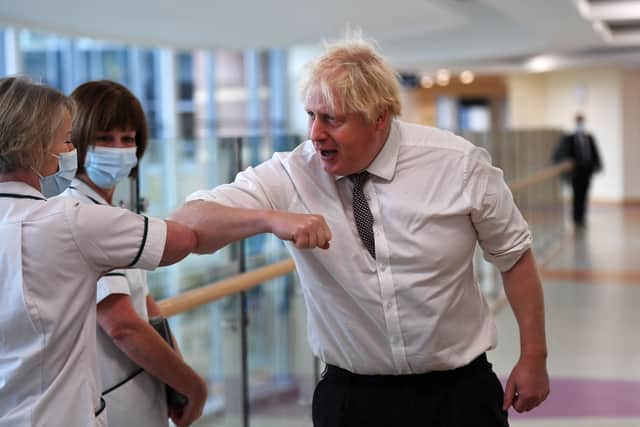 Boris Johnson was accused of showing a “lack of leadership” after being pictured greeting nurses without a mask at Hexham General Hospital. (Credit: Getty)
