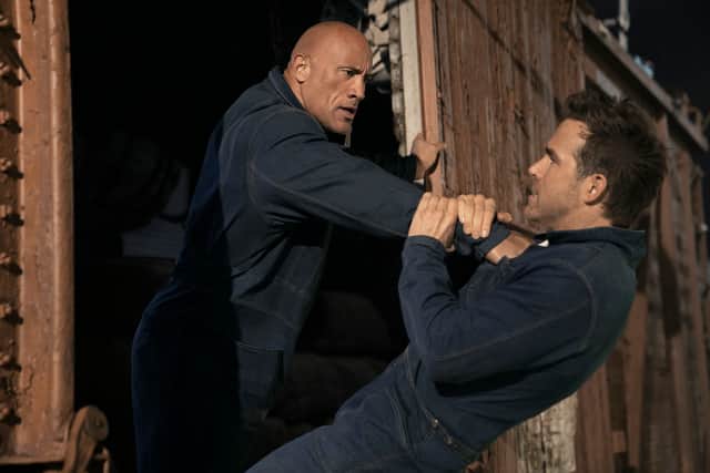 Dwayne Johnson as John Hartley and Ryan Reynolds as Nolan Booth (Picture: Netflix)