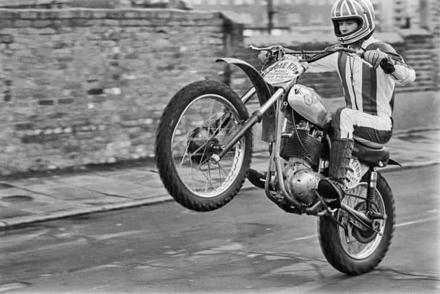<p>Eddie Kidd doing a wheelie on a motorcycle in February 1977 (Photo: Evening Standard/Hulton Archive/Getty Images)</p>