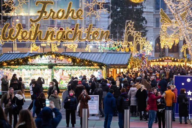 People visit the newly opened “Christkindlmarkt” in Vienna, Austria (Photo: GEORG HOCHMUTH/APA/AFP via Getty Images)