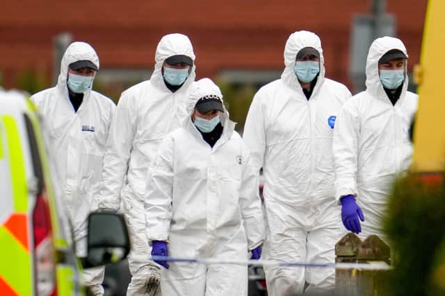 Police officers carrying out forensic investigations at the scene of the car explosion (Photo: Christopher Furlong/Getty Images)