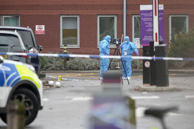 Police officers continue their forensic investigations at the scene of the car explosion at Liverpool Women’s Hospital