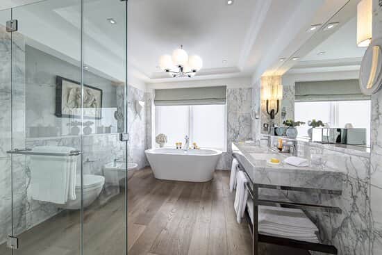 The suite is decked out with a stunning, spacious bathroom with marble tiling 