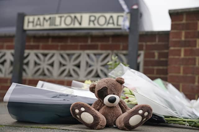 <p>Flowers and teddy bears have been laid at the scene of the house fire that killed two children (image: PA)</p>