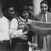 Jamaican men reading a newspaper whilst on board the ‘Empire Windrush’ bound for Tilbury docks in Essex (Photo: Douglas Miller/Keystone/Getty Images)