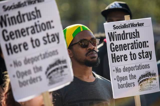 Demonstrators hold placards during a protest in support of the Windrush generation in Windrush Square, Brixton on April 20, 2018 (Photo: Chris J Ratcliffe/Getty Images)