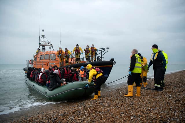 <p>Migrants are brought to shore after a boat capsized in the English Channel while attempting to reach the UK. (Credit: Getty)</p>