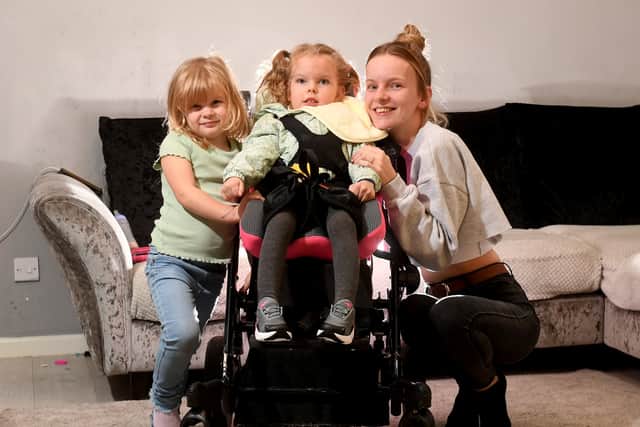 Imogen Holmes aged 5 who suffers from Cerebral Palsy pictured with her mum Briony Winstanley and sister Delilah Holmes aged 4