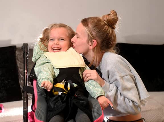 Imogen Holmes aged 5 who suffers from Cerebral Palsy pictured with her mum Briony Winstanley at her home 