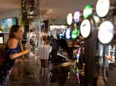 A customer orders drinks at the bar at a Wetherspoon pub in Clapham (Photo: Getty)