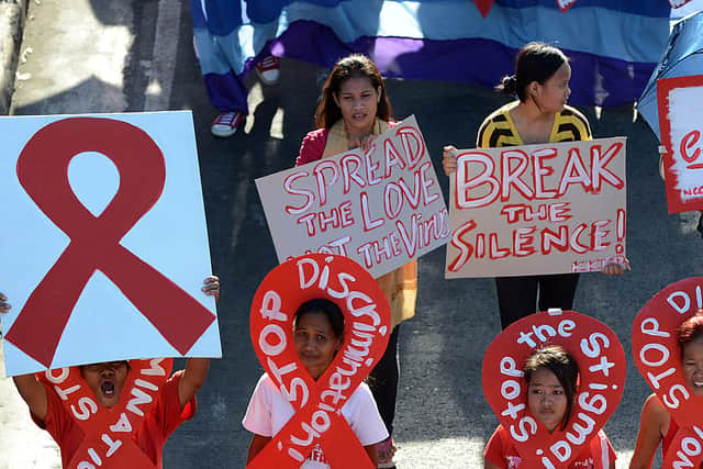 AIDS activists carry a placard during a protest march marking World AIDS Day (Photo: TED ALJIBE/AFP via Getty Images)