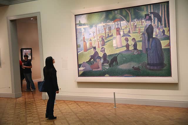 A visitor looks over Georges Seurat’s A Sunday on La Grande Jatte in the Art Institute of Chicago (Photo: Scott Olson/Getty Images)