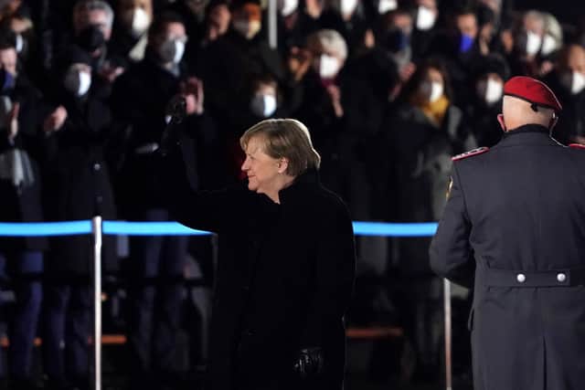 Merkel waves goodbye to the German public during a formal ceremony in Berlin after serving 16 years as Chancellor. (Credit: Getty)