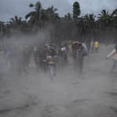 People in East Java villages fleeing their homes as ash is thrown into the air. (Picture: Getty)