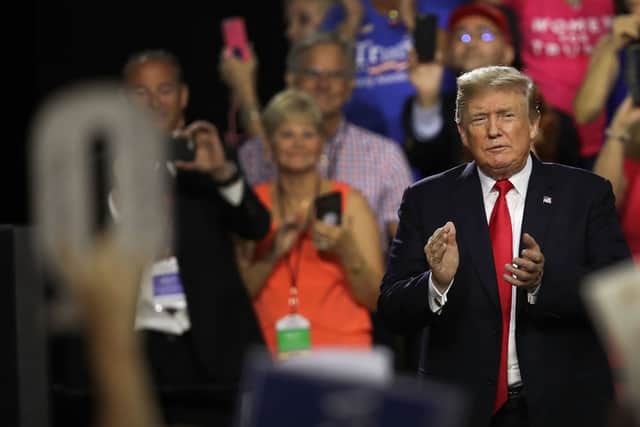 QAnon supporters have been likened to a Trump-worshipping cult (Picture: Getty)