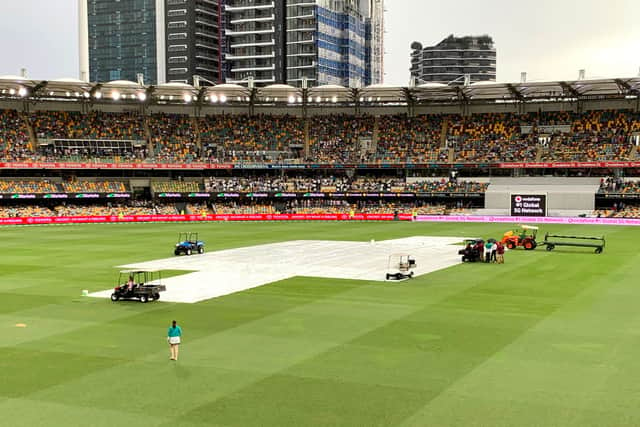 The covers are seen on the pitch as rain delays play during day one of the First Test Match in the Ashes series between Australia and England at The Gabba. (Photo by Bradley Kanaris/Getty Images)