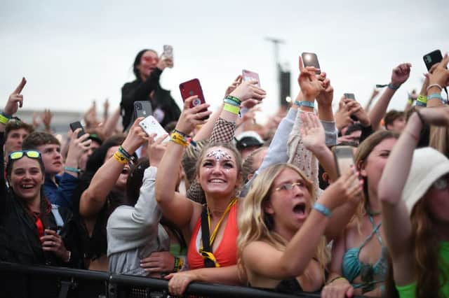 Festival-goers hold up their mobile phones as they watch British rapper AJ Tracey perform at the 2021 Reading Festival (Photo: DANIEL LEAL/AFP via Getty Images)