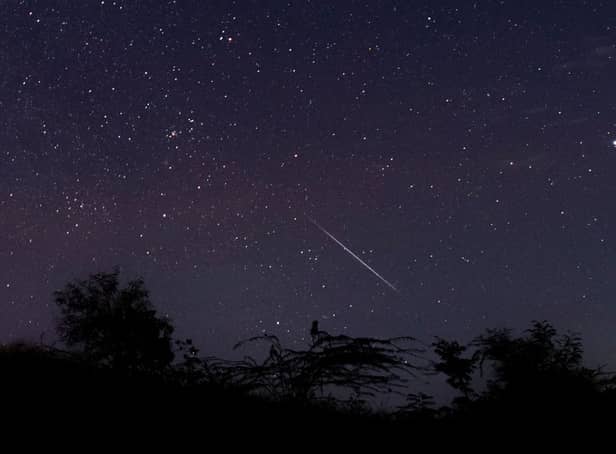 <p>A meteor streaking through the night sky over Myanmar during the Geminid meteor shower in 2018 (Photo: YE AUNG THU/AFP via Getty Images)</p>
