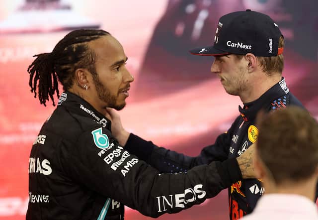 <p>Race winner and 2021 F1 World Drivers Champion Max Verstappen of Netherlands and Red Bull Racing is congratulated by runner up in the race and championship Lewis Hamilton of Great Britain and Mercedes GP during the F1 Grand Prix of Abu Dhabi at Yas Marina Circuit on December 12, 2021 in Abu Dhabi, United Arab Emirates. (Photo by Lars Baron/Getty Images)</p>