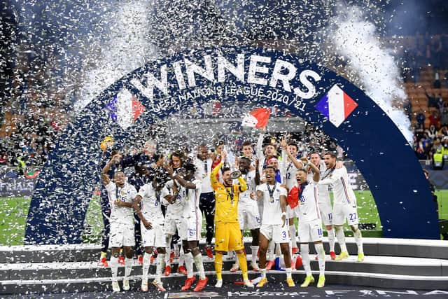 France's goalkeeper Hugo Lloris holds the trophy as he celebrates with teammates during the trophy ceremony at the end of the Nations League final football match between Spain and France at San Siro stadium in Milan, on October 10, 2021
