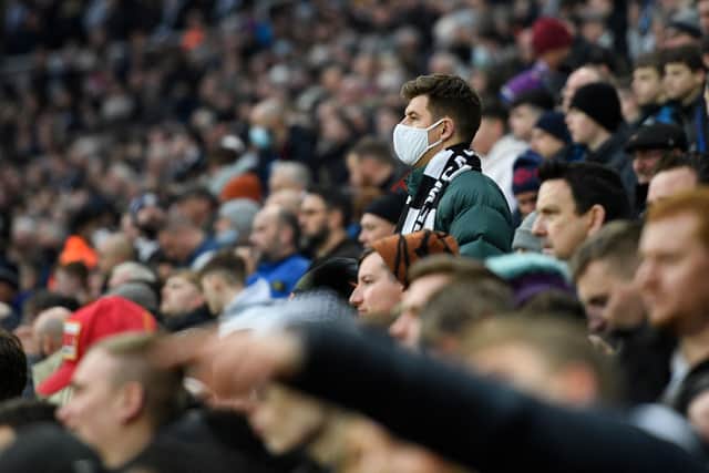 A fan wearing a face covering to combat the spread of the coronavirus looks on during the English Premier League football match between Newcastle United and Manchester City (Photo: Getty)