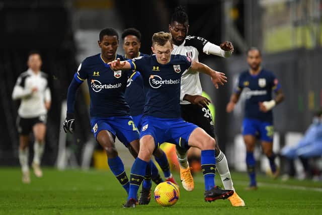 James Ward-Prowse of Southampton holds off Andre-Frank Zambo Anguissa of Fulham during the Premier League match between Fulham and Southampton at Craven Cottage on December 26, 2020