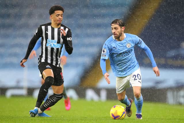 Bernardo Silva of Manchester City takes on Jamal Lewis of Newcastle United during the Premier League match between Manchester City and Newcastle United at Etihad Stadium on December 26, 2020