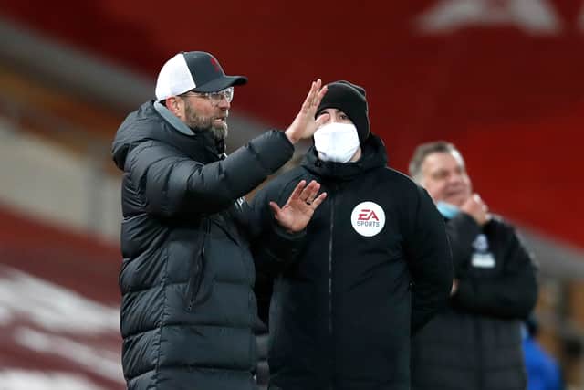 Jurgen Klopp, Manager of Liverpool talks with Fourth Official Chris Kavanagh during the Premier League match between Liverpool and West Bromwich Albion at Anfield on December 27, 2020