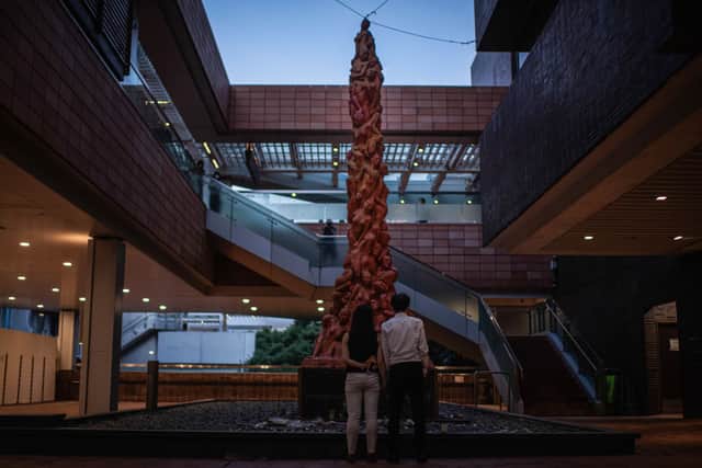 A couple looks at the Pillar of Shame statue, an eight-metre tall monument to the Tiananmen Square Massacre by Danish artist Jens Glaschiø (Photo: Louise Delmotte/Getty Images)