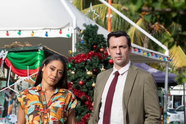 <p>Josephine Jobert as DS Florence Cassell and Ralf Little as DI Neville Parker in Death in Paradise (Credit: BBC / Red Planet / Denis Guyenon)</p>