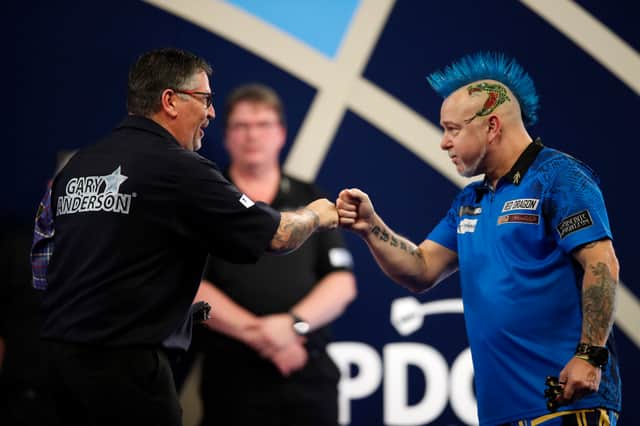 <p>Gary Anderson of Scotland and Peter Wright of Scotland congratulate each other after their Semi-Finals Match during Day Fifteen of The William Hill World Darts Championship at Alexandra Palace on January 02, 2022</p>