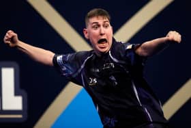 William Borland of Scotland reacts to a nine dart finish during his First Round match against Bradley Brooks of England during the William Hill World Darts Championship at Alexandra Palace on December 17, 2021