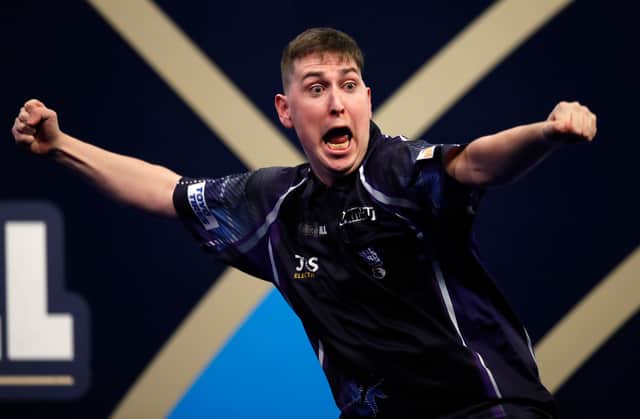 William Borland of Scotland reacts to a nine dart finish during his First Round match against Bradley Brooks of England during the William Hill World Darts Championship at Alexandra Palace on December 17, 2021