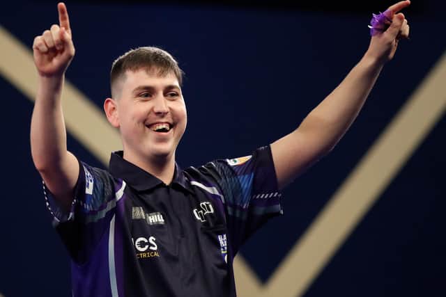 William Borland of Scotland reacts to a nine dart finish during his First Round match against Bradley Brooks of England during the William Hill World Darts Championship at Alexandra Palace on December 17, 2021 in London, England