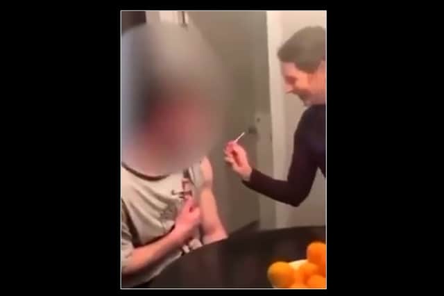 A social media video appears to show Laura Russo giving a 17-year-old a Covid vaccine dose (image: CBS)