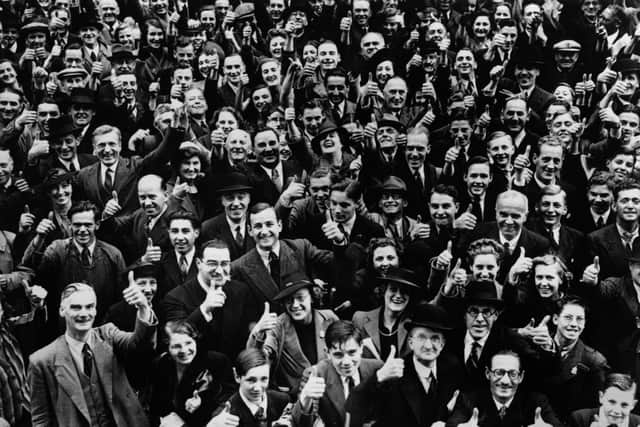 A crowd of smiling faces greet Winston Churchill during his visit to bomb damaged areas in the City of London.  (Photo by Reg Speller/Fox Photos/Getty Images)