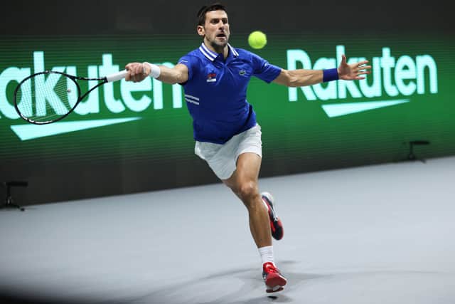 Novak Djokovic of Serbia plays a forehand to Marin Cilic of Croatia during the Davis Cup semi final between Serbia and Croatia at Madrid Arena on December 03, 2021 in Madrid, Spain.