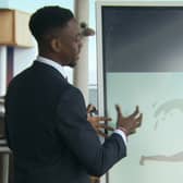 Akeem presents the logo for their cruise company (Photo: BBC)