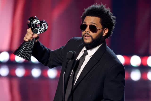 The Weeknd accepting the Male Artist of the Year onstage at the 2021 iHeartRadio Music Awards (Photo: Kevin Winter/Getty Images for iHeartMedia)