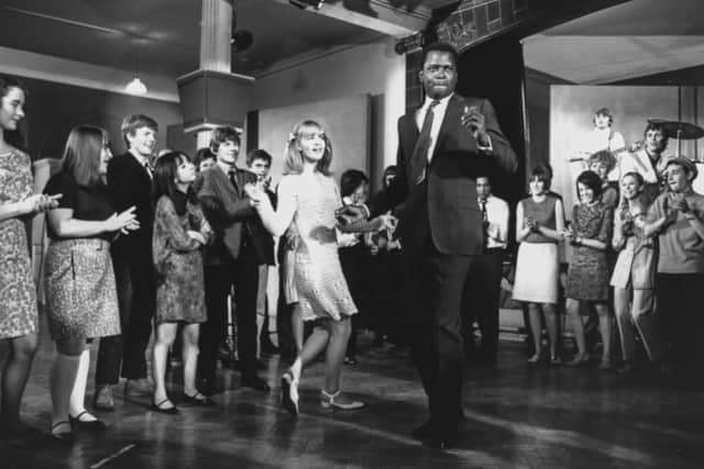 Sidney Poitier and Judy Geeson dancing in front of a crowd in a scene from the film ‘To Sir, With Love’, filmed at Victoria Barracks in Windsor, England, 1967. (Photo by Chris Ware/Keystone Features/Getty Images)
