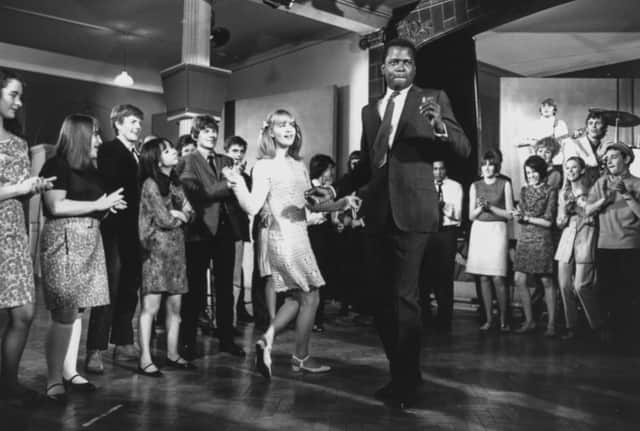Sidney Poitier and Judy Geeson dancing in front of a crowd in a scene from the film ‘To Sir, With Love’, filmed at Victoria Barracks in Windsor, England, 1967. (Photo by Chris Ware/Keystone Features/Getty Images)