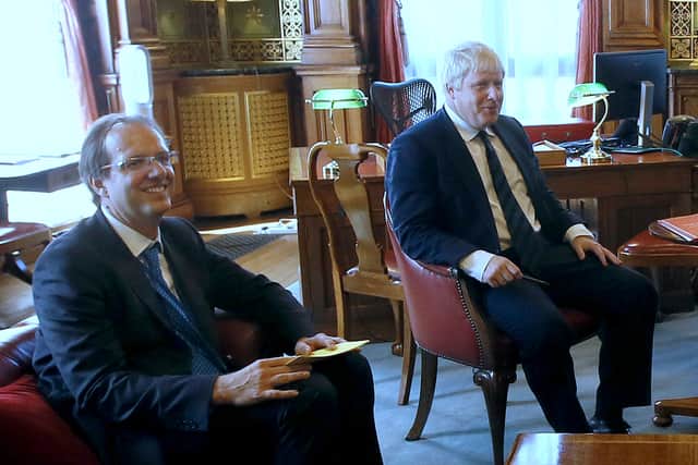 Prime Minister Boris Johnson with his principal private secretary, Martin Reynolds (left), who sent an email to more than 100 Downing Street employees asking them to “bring your own booze” for an evening gathering, ITV reported (image: PA)
