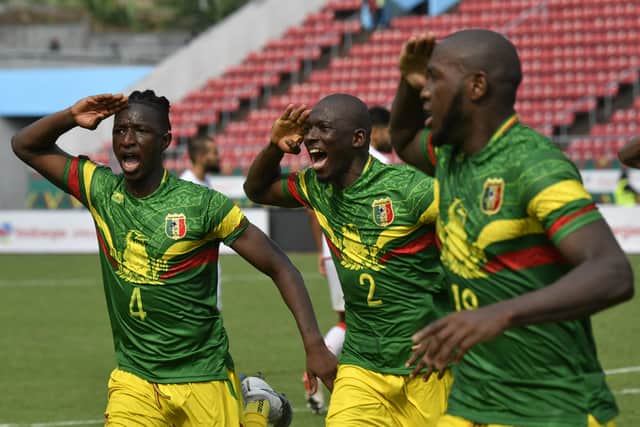 Mali's midfielder Amadou Haidara (L) and Mali's defender Hamari Traore celebrate the goal scored by Mali's forward Ibrahima Kone (R)  during the Group F Africa Cup of Nations (CAN) 2021 football match between Tunisia and Mali at Limbe Omnisport Stadium in Limbe