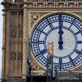 Workers remove the scaffolding from the restored west dial of the clock on Elizabeth Tower, commonly known by the name of the bell Big Ben (Photo: TOLGA AKMEN/AFP via Getty Images)