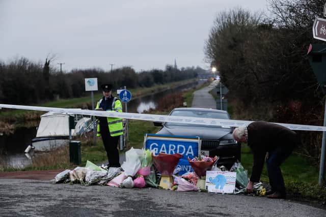 A man lays flowers with other floral tributes left near to the Grand Canal in Tullamore, County Offaly, where Aisling Murphy was murdered.
