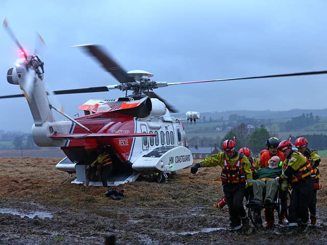 Specialist rescue crews from HM Coastguard Rescue Service and The Scottish Fire and Rescue Service help to rescue an elderly couple and their two dogs whose house was in danger of flooding (Photo by Mark Runnacles/Getty Images)