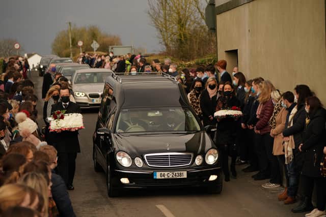 Mourners walk beside the hearse as the cortege arrives at St Brigid’s Church, Mountbolus, Co Offaly, for the funeral of Ashling Murphy.