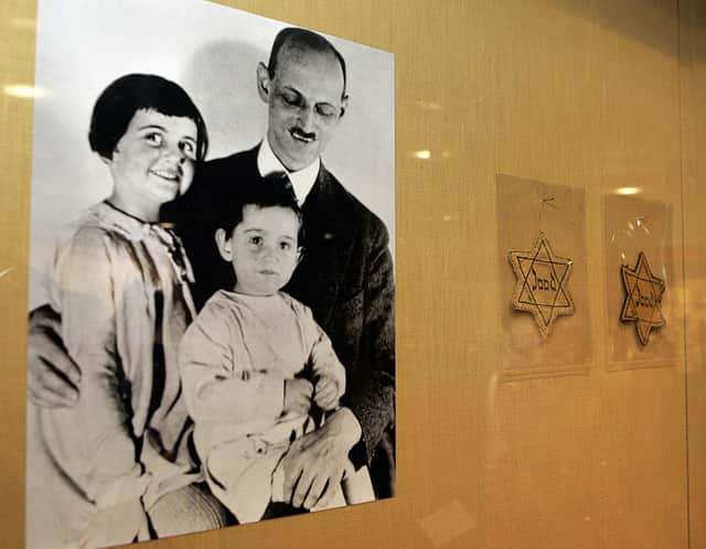 Anne Frank (pictured, c, with her father Otto and sister Margot) was born in Germany just before it came under full Nazi control (image: AFP/Getty Images)